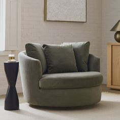 a living room with a round chair and side table