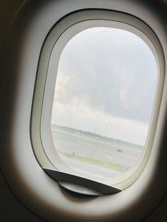 an airplane window looking out on the tarmac