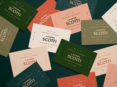 many different colored business cards on a black surface with the word scott printed on them