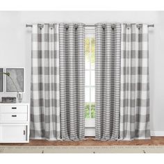 the curtains are hanging in front of a window with white and gray checkered drapes