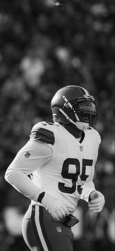 a black and white photo of a football player