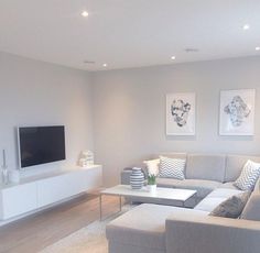 a living room filled with furniture and a flat screen tv on top of a wall