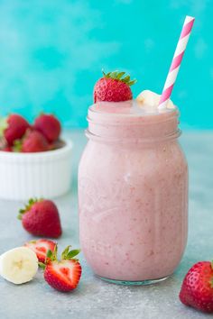 strawberry banana smoothie in a mason jar with strawberries