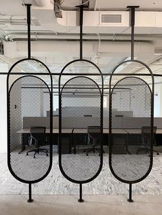 an office cubicle with four black privacy screens