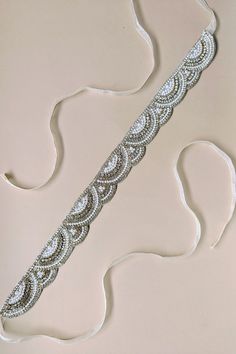 KALEO BELT - STYLE 5147 Hand sewn with light silver thread to a soft ivory tulle Two inches wide Self-tie with our silk light ivory ribbon The embellishment is 20 inches in length and 1 inch wide Ribbon is 54 inches in length Hypoallergenic: Nickel, cadmium and lead-free Handmade with Austrian crystals Item ships in signature keepsake packaging Wedding Belt, Light Ivory, Wedding Belts, Belt Style, Bride Look, Austrian Crystal, Crystal Items, Bridal Wedding, Hand Sewn