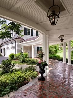 the front porch is covered with plants and potted trees