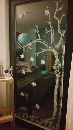 a glass door with a tree drawn on it