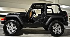 a black jeep parked in a parking garage