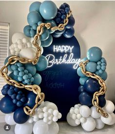 a birthday balloon arch with balloons and chains