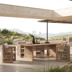 an outdoor dining table with chairs around it