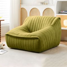 a green chair sitting on top of a white rug