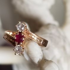 a close up view of a ring with two stones on it and one stone in the middle