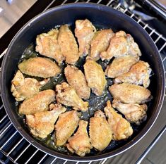 chicken is cooking in a skillet on the stove