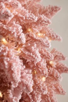 a pink christmas tree with lights on it