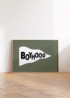 a poster with the word boyhood printed on it in front of a white wall