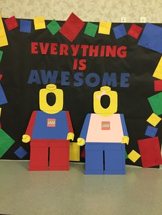 two legos standing next to each other in front of a sign that says everything is awesome