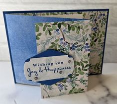 a blue and white greeting card with an envelope that says wishing you joy & happiness