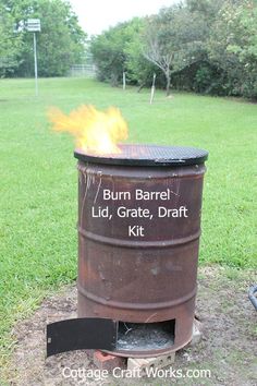 a barrel with fire in it sitting on the ground