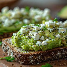 an avocado sandwich with feta cheese and herbs