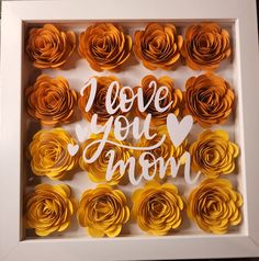 paper flowers in a shadow box with the words i love you mom