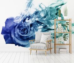 a blue rose wall mural in a living room with a chair and bookshelf