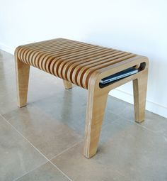 a wooden bench sitting on top of a tile floor