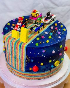 a birthday cake decorated with an image of mario kart and friends on the top