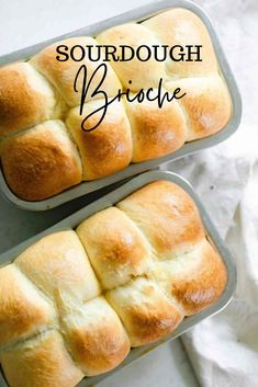 two pans filled with bread sitting on top of a white tablecloth next to each other