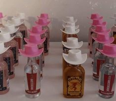 several bottles with hats on them are lined up next to each other and one is empty