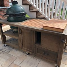 an outdoor bbq with a large grill on it's side and stairs in the background