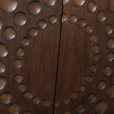 a wooden cabinet with lots of circles on it