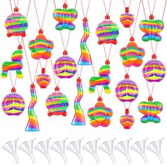 a group of colorful objects hanging from strings on a white background with clippings