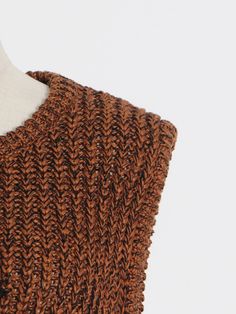 the back of a brown knitted sweater on a mannequin headdress