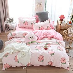 a bed with pink sheets and pillows in a room