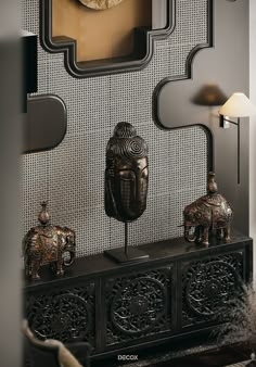 an elephant statue is on top of a shelf in front of a mirror and lamp