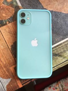 an iphone case sitting on top of a wooden table