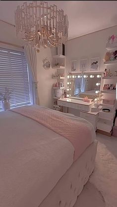 a bedroom with a chandelier hanging from the ceiling and a bed in front of a window