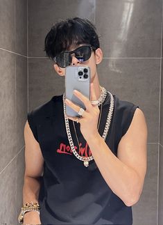 a man taking a selfie with his cell phone in front of him and wearing sunglasses