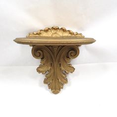 an ornately carved shelf is shown against a white background