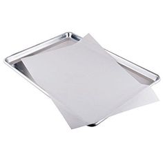 a metal tray with paper on top of it and a white sheet of paper in the middle