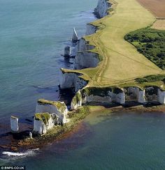 an aerial view of the white cliffs on the coast