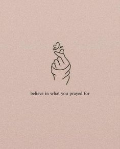 a hand holding a flower with the words believe in what you praying for