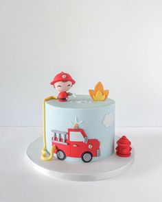 a birthday cake with a fireman on top