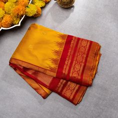 Mustard Yellow Double weave Gadwal best quality zari handwoven saree with Maroon borders exclusive | SILK MARK CERTIFIED is a mesmerizing ode to natural beauty and artistic finesse. Its Kanchi border pattern, delicately woven, evokes the serene majesty of bright landscapes. Enhanced by contrasting Maroon borders, the saree exudes a striking allure, balancing subtlety with vibrancy.  Material Gadwal silk Size 6.2 m x 1.14 m Craft Gadwal handloom Telangana Ready to wear with fall and pico done.  Handmade Designer silk tassels adorn the pallu  SILK MARK CERTIFIED Blouse - Unstitched SAREE Craft : Handwoven Pattern : All over Purity : Pure Saree Color :Mustard Saree Fabric : Fabric Silk Saree length : 5.5 Mtrs Saree Work : Woven BORDER/PALLU Saree Border Color : Maroon Saree Border Fabric :Sil Traditional Festive Pre-draped Saree With Border, Gold Saree With Zari Weaving For Rituals, Diwali Rituals Pre-draped Saree With Zari Weaving, Festive Pre-draped Saree With Zari Weaving For Rituals, Festival Pre-draped Saree With Zari Weaving For Rituals, Tussar Silk Anarkali For Rituals, Gold Tussar Silk Saree For Rituals, Navratri Saree With Zari Weaving For Rituals, Anarkali Tussar Silk Traditional Wear For Rituals