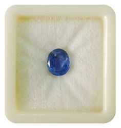 a blue gems sits in a white box