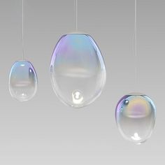 three soap bubbles hanging from strings with the word ariande written below them in white