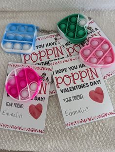 four valentine's day cards with popspies in them sitting on a bed next to each other