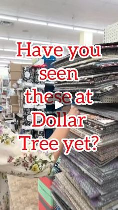 a woman in a store with stacks of clothes and the words have you seen these at dollar tree yet?