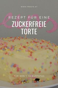 a white cake with sprinkles on it and the words regent fur eine zuckerfrie torte