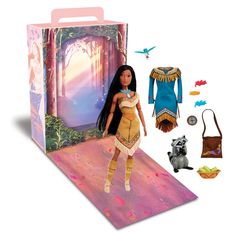 the doll is in its box with other items around it, including clothing and accessories